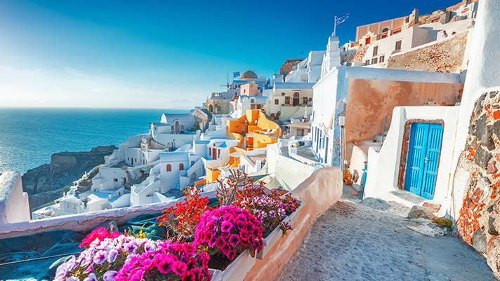Explore dreamy destinations like Santorini, Greece. 