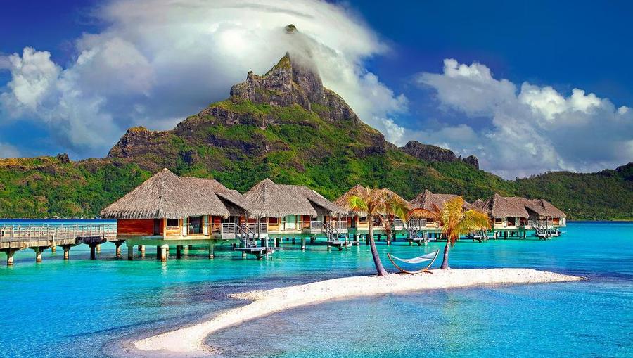 A landscape shot of Bora Bora's overwater bungalows and mountain.