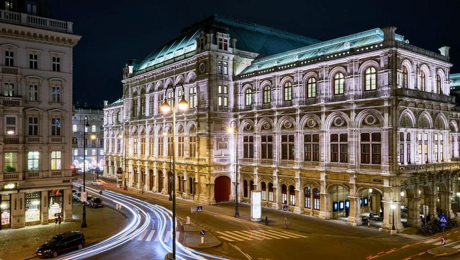 Vienna at nightime with bright lights on the street