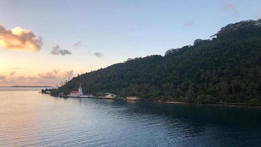 The view from MS Paul Gauguin pulling into Taha'a at sunset.