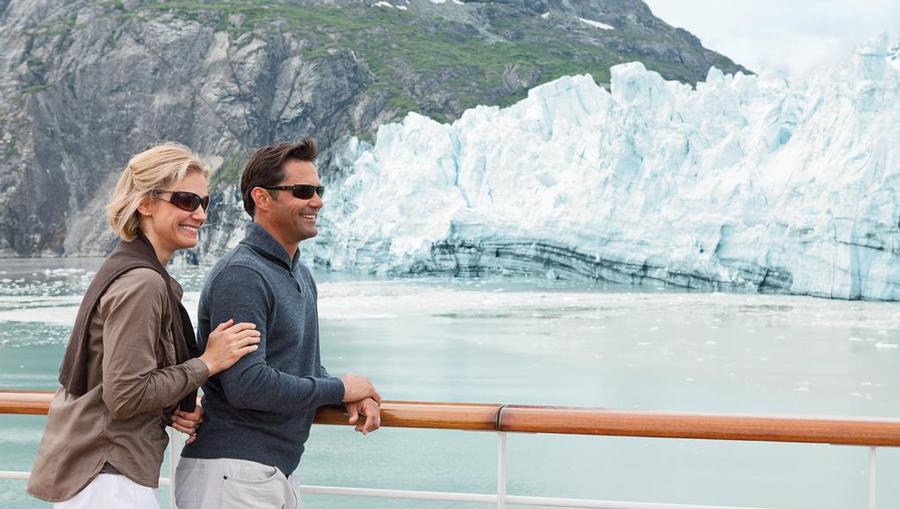A couple enjoying Alaskan views from the ship's deck.