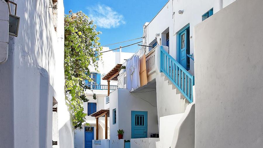 A street view of the iconic white buildings in Mykonos, Greece.