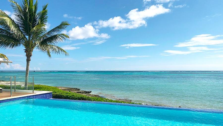 Beautiful pool overlooking the water with a pristine view.