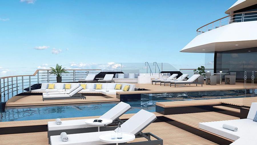 A rear view of a yacht with lounge chairs and a pool.