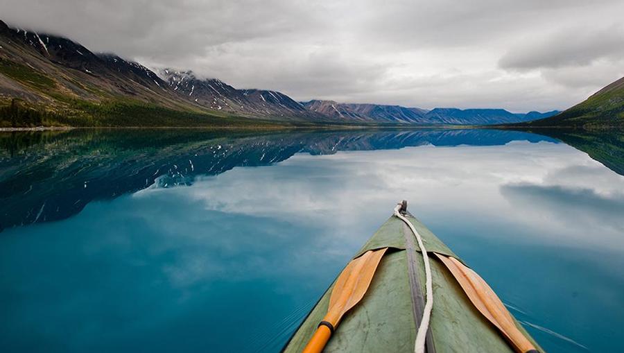 A first person perspective from a kayak floating in the water.