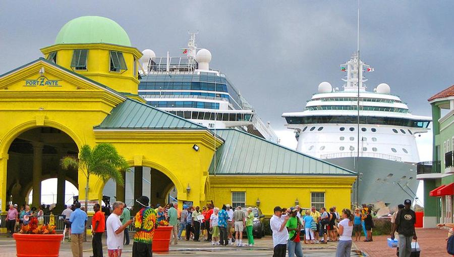 A view of Port Zante in St Kitts with open air shopping and a cruise ship in the background.