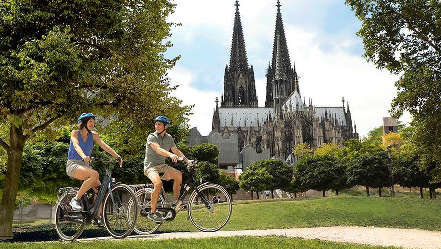 A couple biking on an AmaWaterways excursion in Europe.