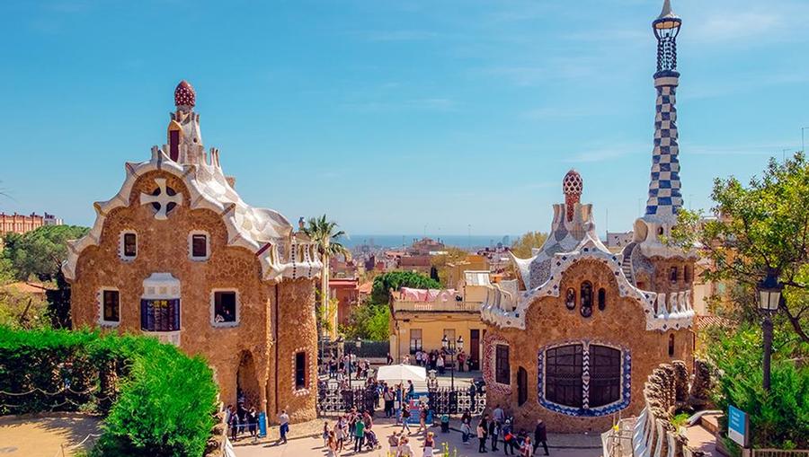 People strolling through the charming Park Guell cultural center located in the heart of the city.