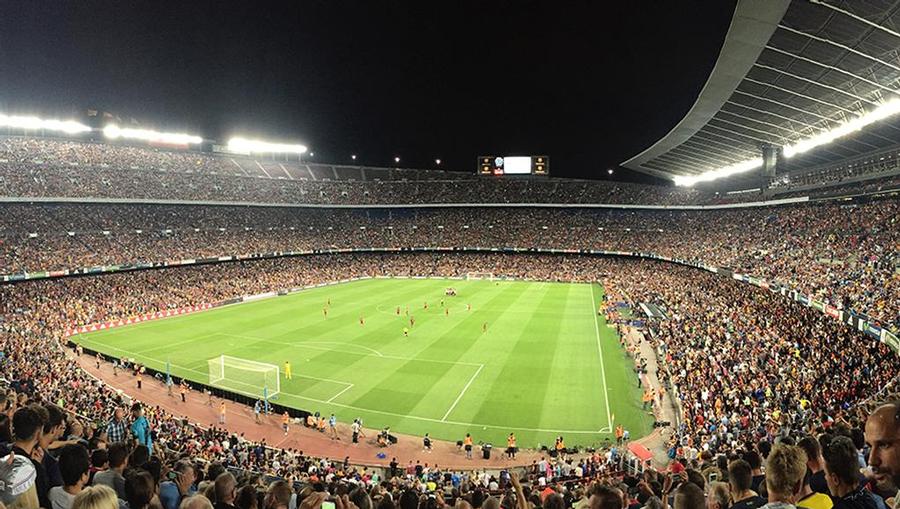 Camp Nou futbol field and home of the FC Barcelona team packed with 99,400 cheering fans during a game.