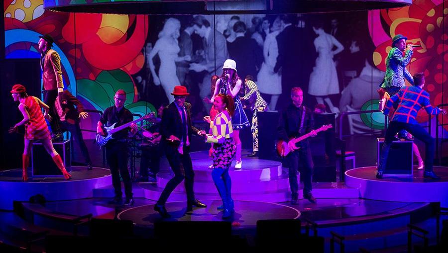 A live band rocks the stage at Billboard Onboard on the Holland America Koningsdam cruise ship.