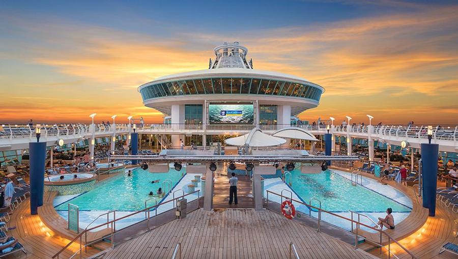 Royal Caribbean's Adventure of the Seas top deck pools at sunset.
